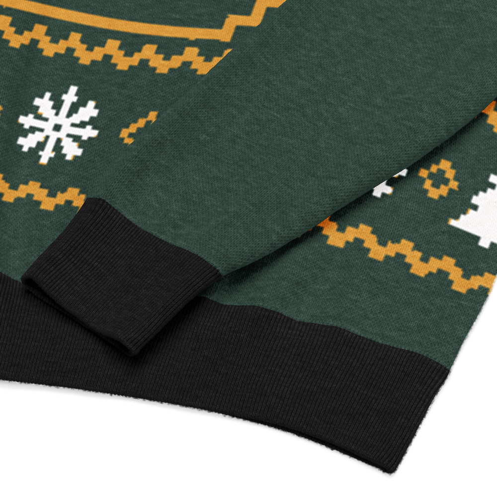 Winter Fairway, Nahaufnahme von Jacquard-Strick, weißen Schneeflocken, goldfarbenen Musterbändern und schwarzen Bündchen.